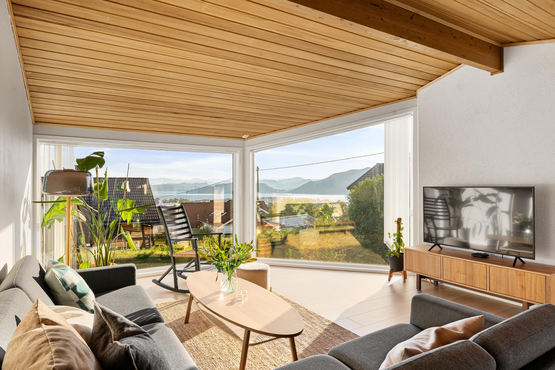 Velkommen til Markveien 7A. Foto: [DIRDAL FOTO AS]. Stuen i tilbygget har store vindusflater med vidstrakt utsikt mot fjorden og fjellene.. Bilde nummer 1 av 3