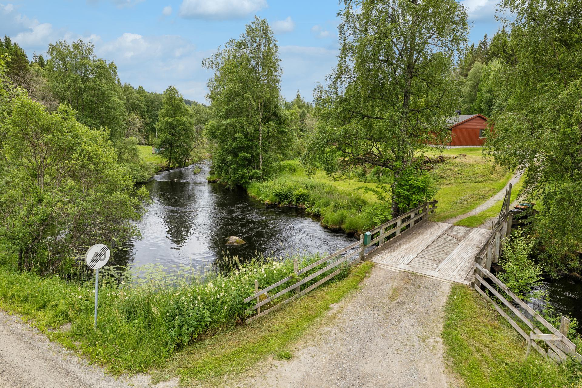 Egen bro over Moelva, oppført ny i 1998, gir adkomst til denne idylliske eiendommen.. Bilde nummer 2 av 3