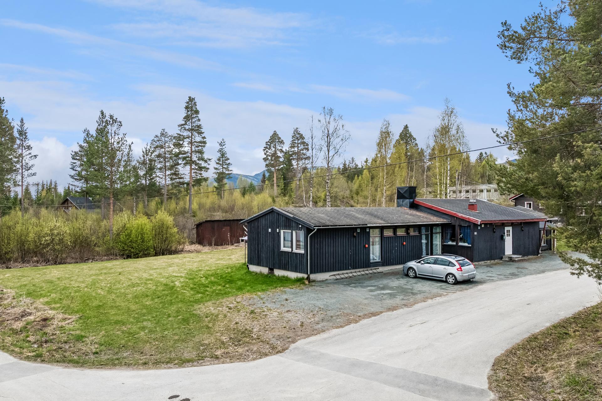 Den store hagen ligger i et rolig boligområde med en blanding av eneboliger og gårdsbruk. Bilde nummer 2 av 3