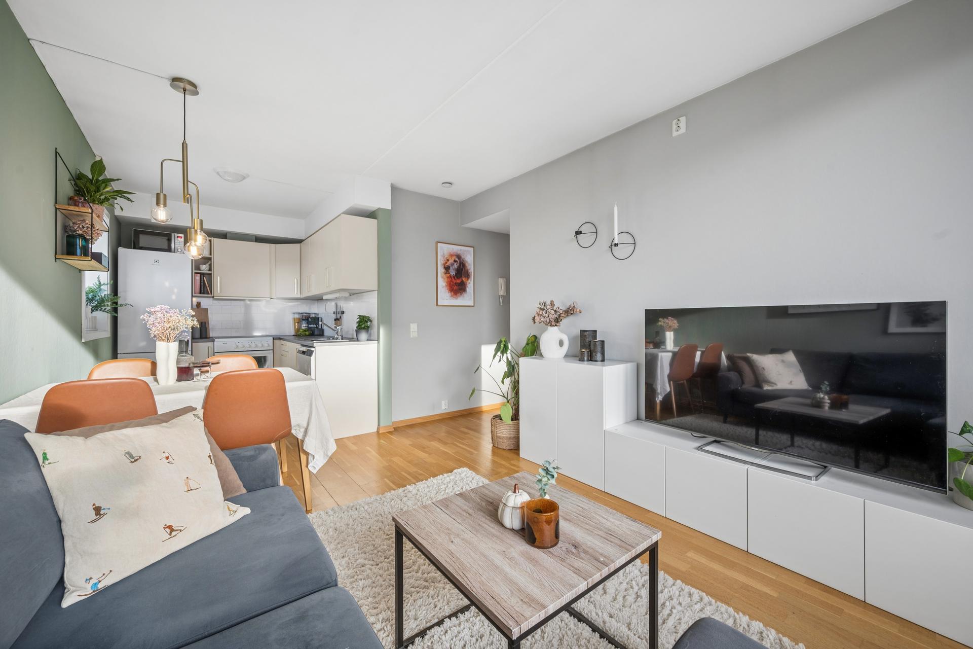 Innbydende leilighet med åpen stue/kjøkkenløsning, 3-stavs parkett og god plass til både sofagruppe og spisebord.. Bilde nummer 3 av 3