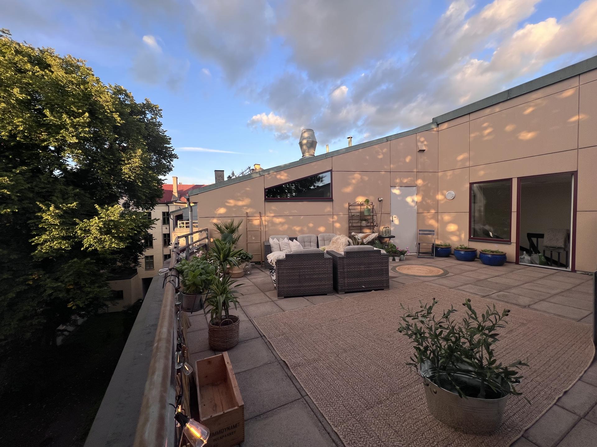 Felles takterrasse rett utenfor inngangsdøren til 5.etasje, med hellelagt dekke og rikelig med plass til sosiale sammenkomster.. Bilde nummer 3 av 3