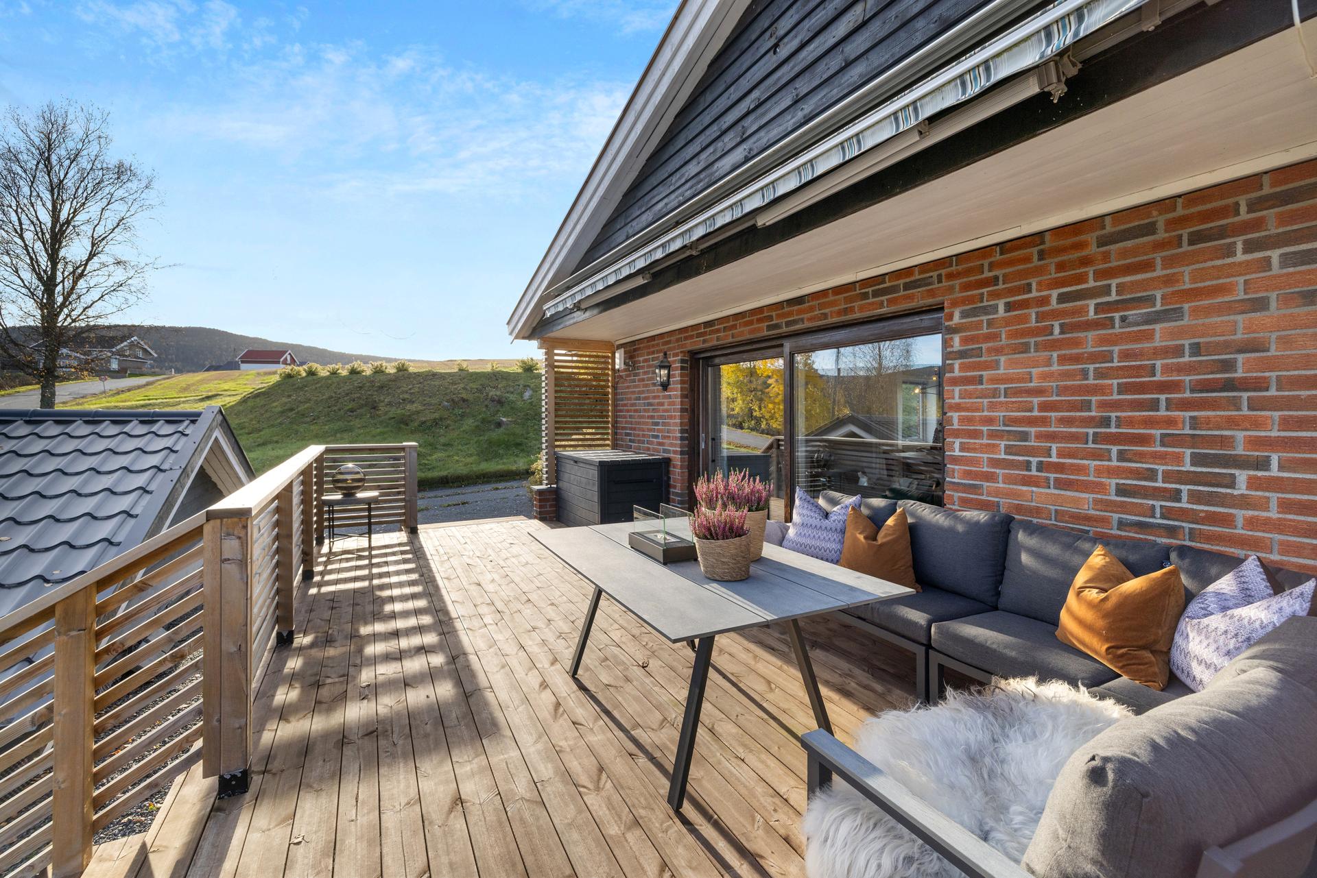 Fra stuen er det direkte utgang til en sørøstvendt terrasse med god plass til utemøbler. Bilde nummer 2 av 3