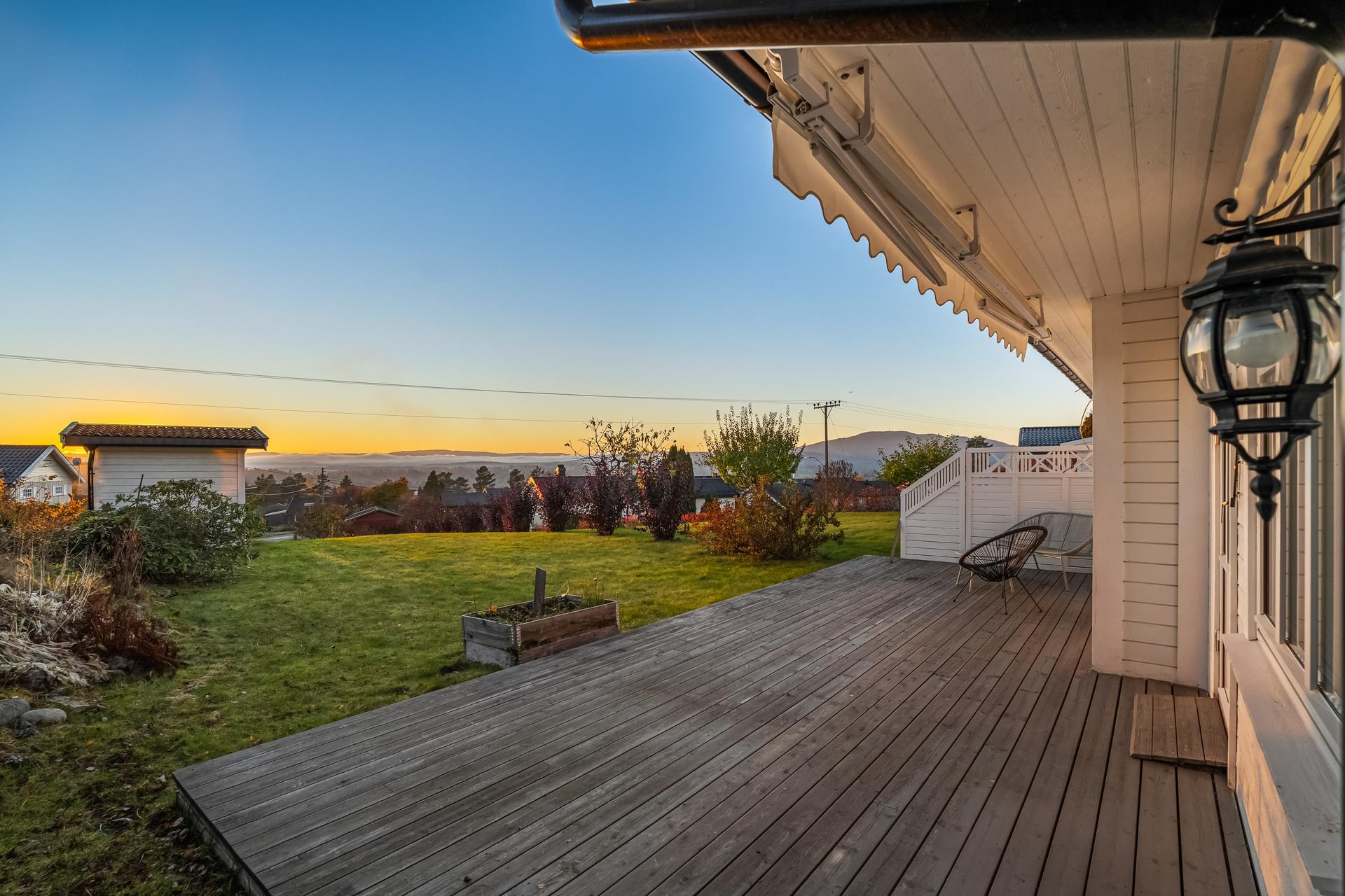 Tomannsbolig over ett plan med terrasse ut fra stuen og utsikt over landskapet.. Bilde nummer 3 av 3