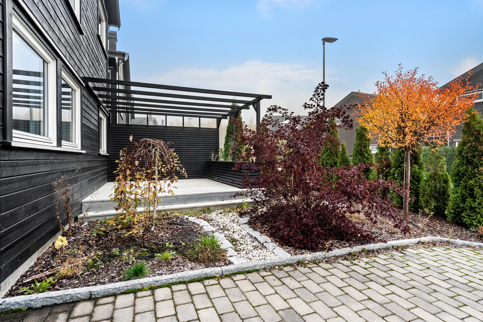 Uteområdet er pent opparbeidet med beplantning og steinbelagt gårdsplass.. Bilde nummer 3 av 3