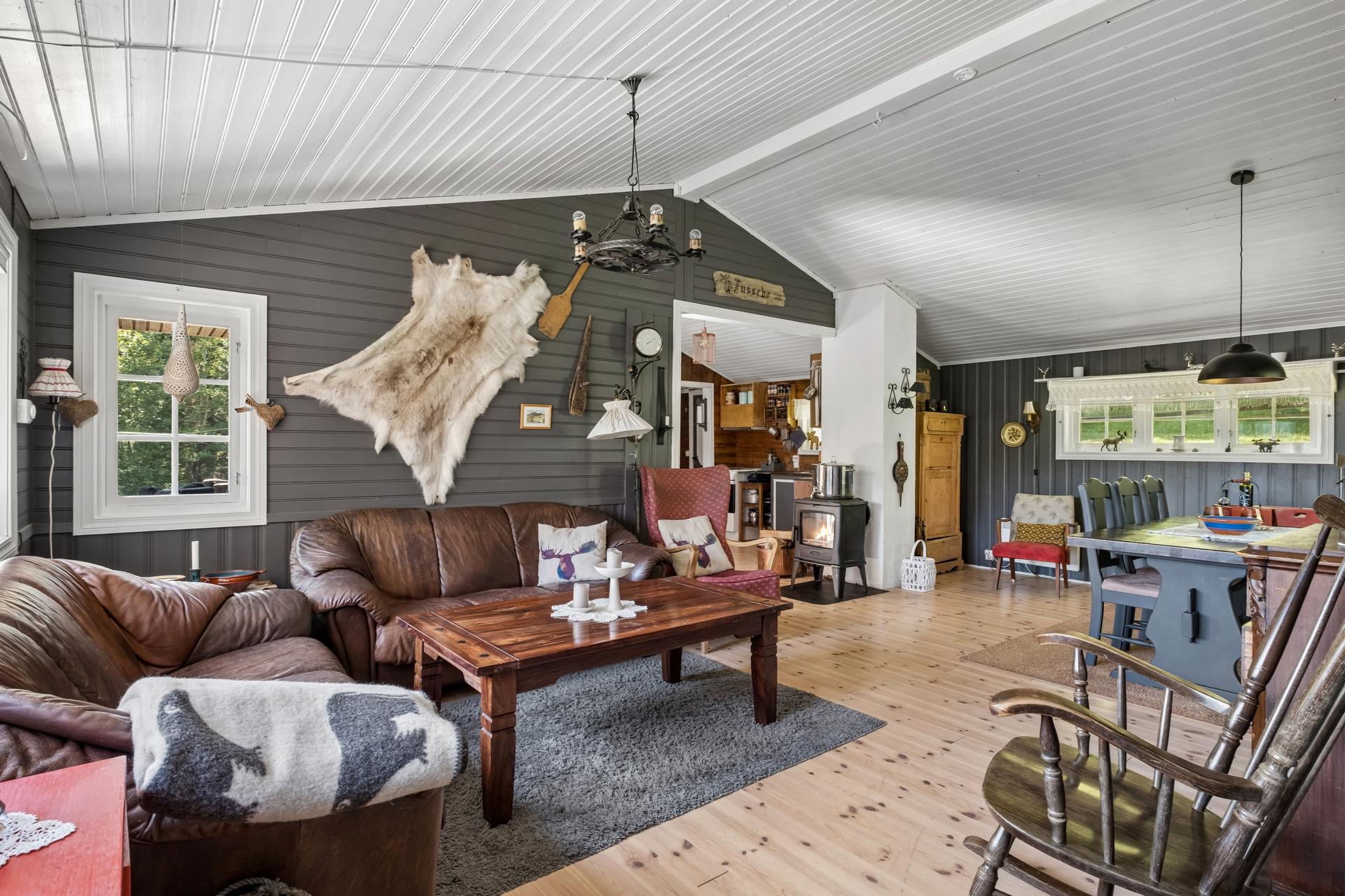 Stuen er samlingspunktet med vedovn for varme og hygge. Gulvet ble lagt nytt i 2016.. Bilde nummer 3 av 3