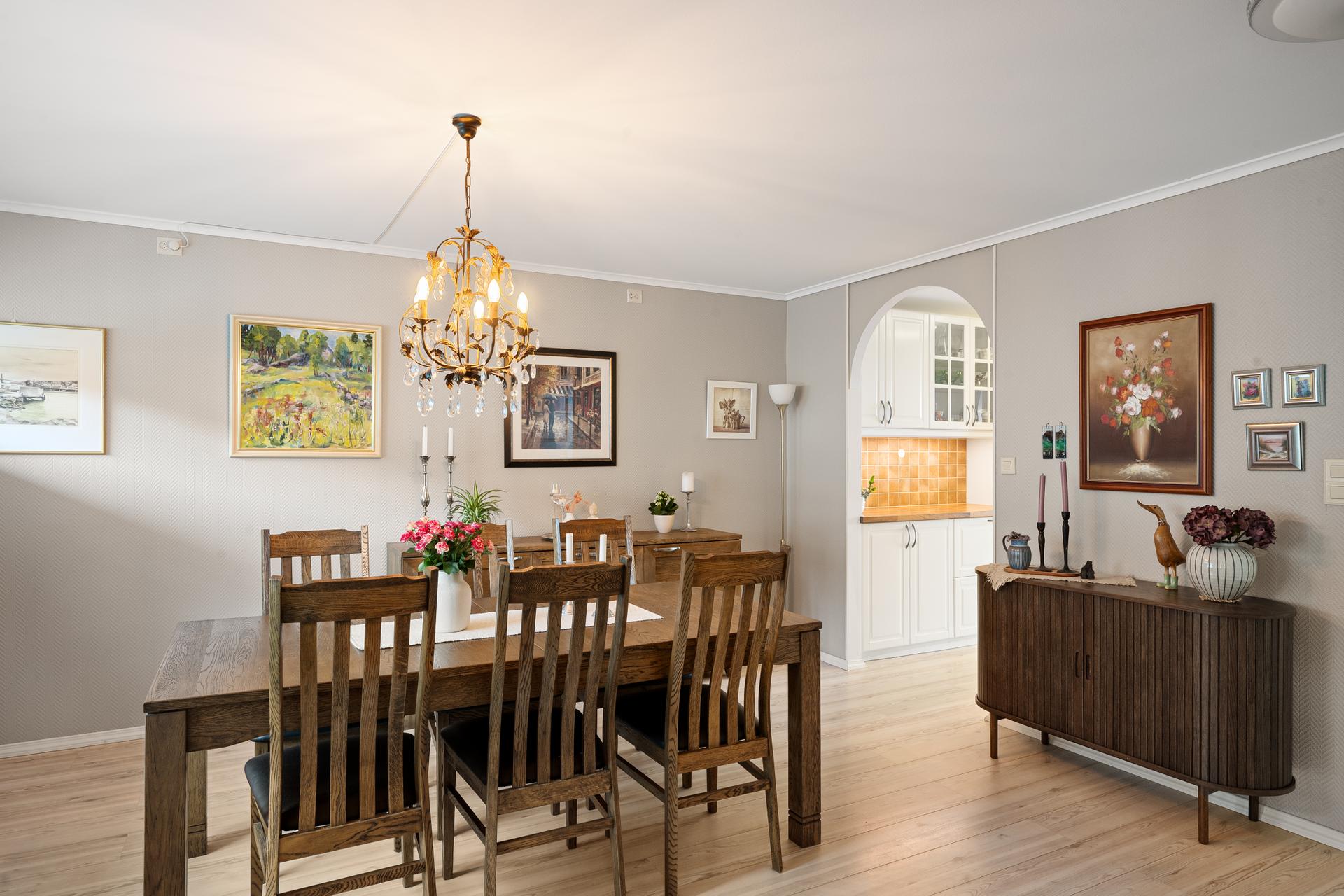 Spisestuen har god plass til langbord og ligger i åpen forbindelse med kjøkkenet.. Bilde nummer 3 av 3