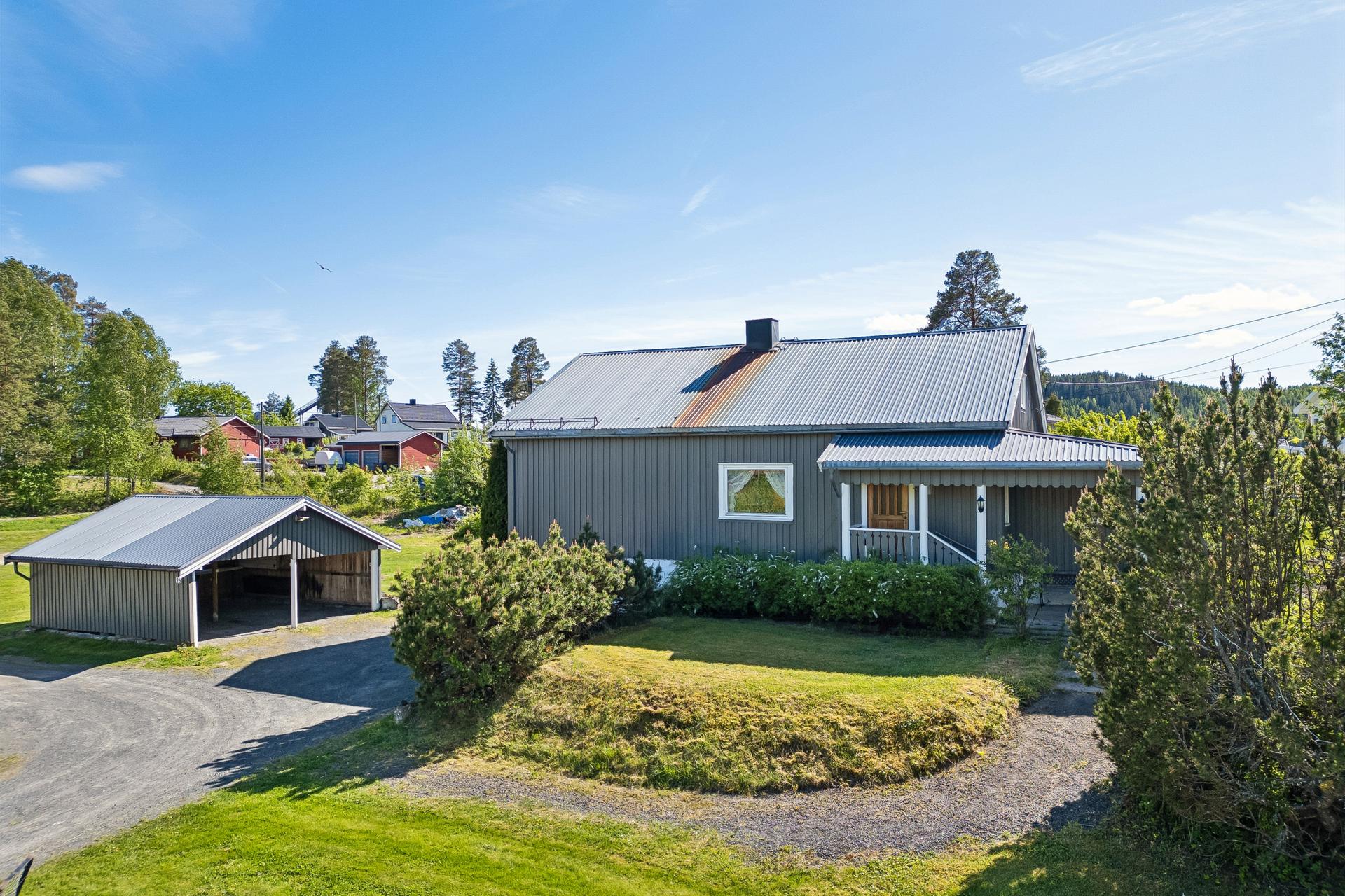 Enebolig oppført i 1956 med tilbygg fra 1985. Eiendommen inkluderer også et uthus med carport og en frittstående carport.. Bilde nummer 2 av 3