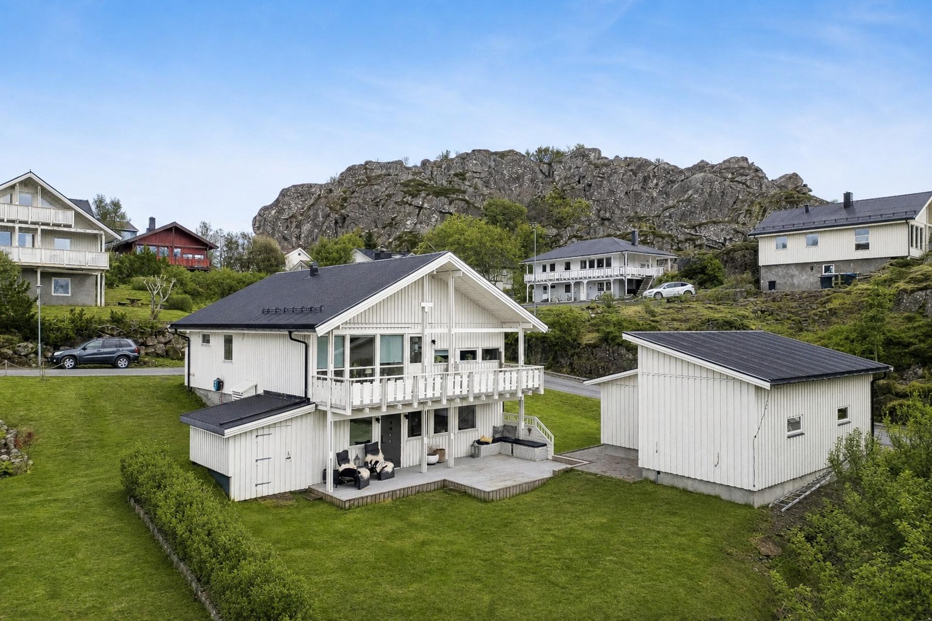 Velkommen til Nakkenveien 28 - Presentert av EiendomsMegler1 Svolvær. (*AI-redigert til sommerbilde) 
Foto: EFKT. Bilde nummer 1 av 3