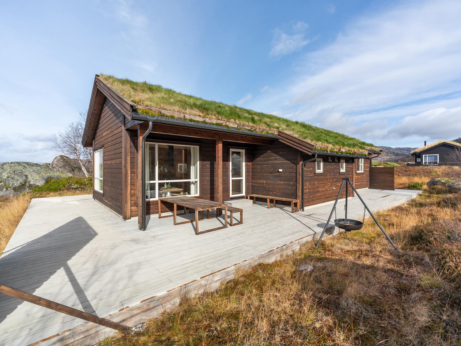 Innholdsrik fritidsbolig fra 2013 oppført over ett plan med torvtak og stor omkringliggende terrasse.. Bilde nummer 3 av 3