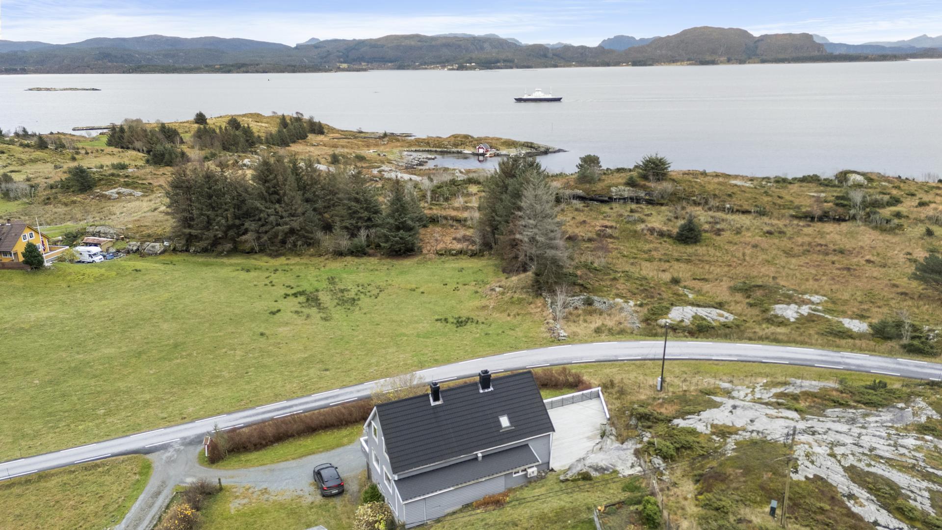 Eigedommen ligg fint til i landlige omgivelser på Atløy. Bilde nummer 3 av 3
