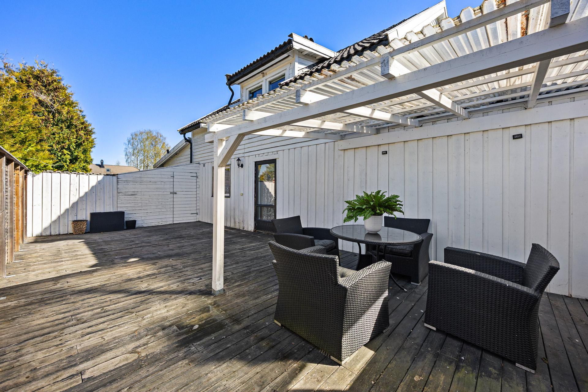 Den vestvendte terrassen i trekonstruksjon er på 50 m², med god plass for utemøbler og sosiale soner.. Bilde nummer 3 av 3