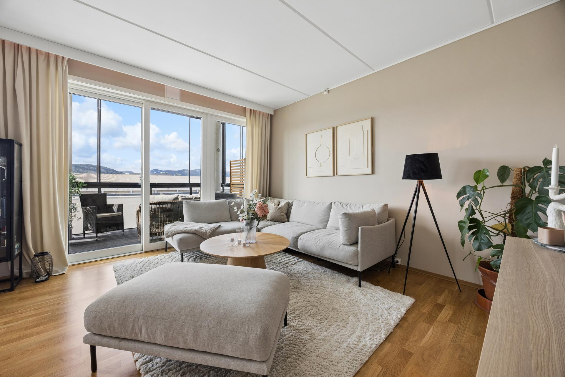 Stuen er lys og innbydende med moderne fargevalg og parkett på gulvet. . Bilde nummer 1 av 3