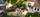 Uteområdet byr på en romslig treterrasse på bakkeplan med skjermede sitteplasser og beplantning.. Bilde nummer 3 av 3